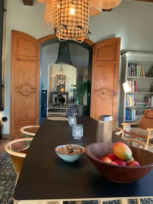 a kitchen with a table with a bowl of fruit on it at La Bastide des Grands Chênes in Lambesc