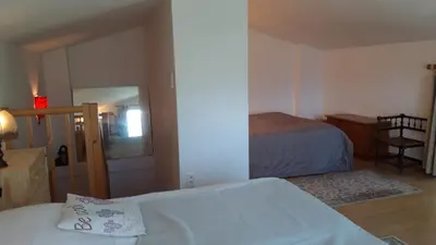 a small bedroom with two beds and a mirror at Mini gite foulon in Crillon-le-Brave