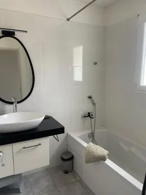 a white bathroom with a sink and a bath tub at Villa Lisa - piscine chauffée in LʼIsle-sur-la-Sorgue