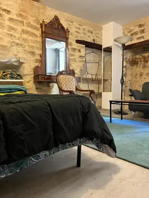 a flat screen tv sitting on a wooden table at APPARTEMENT CAROMB proche Mont VENTOUX avec clim in Caromb