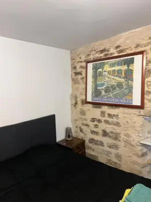 a living room with a lamp and a couch at APPARTEMENT CAROMB proche Mont VENTOUX avec clim in Caromb