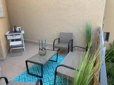 a patio with two chairs and two tables and a table at Beau T2 clim terrasse idéalement situé in Aix-en-Provence