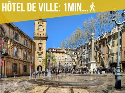 a city square with a clock tower in the middle at Lou Pitchoun in Aix-en-Provence