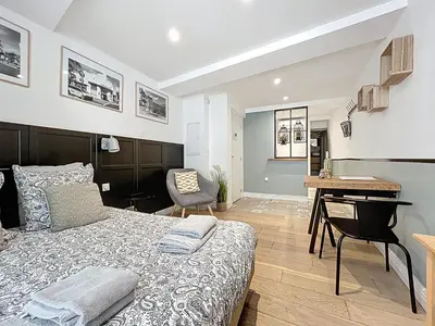 a bedroom with a bed and a desk in a room at Lou Pitchoun in Aix-en-Provence