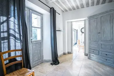 a living room with a door and a window at Gîte tout confort - jardin et piscine in Lagnes