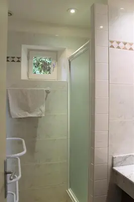 a shower with a glass door in a bathroom at Bastidon avec piscine Gordes Lubéron in Gordes
