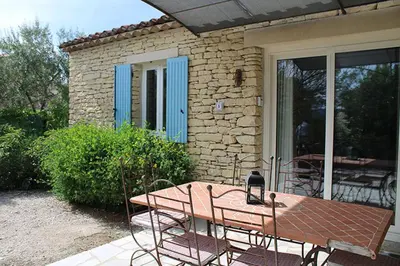 a table and chairs in front of a house at Bastidon avec piscine Gordes Lubéron in Gordes