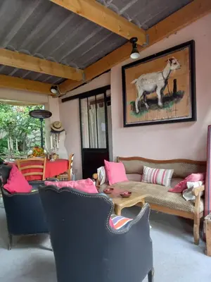 a living room with a couch and a table at Le jardin de Sabine in Éguilles