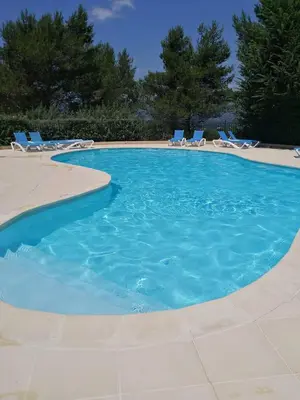a large swimming pool with chairs at Apartement Beata in Provence, Golf Pont Royal in Mallemort
