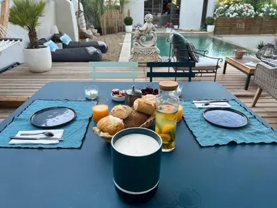 a blue table with food and drinks on it at La Chambre Cézanne in Aix-en-Provence