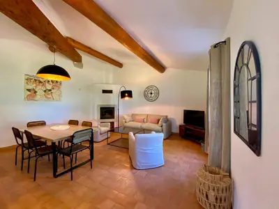 a living room with a table and chairs and a couch at Domaine Perréal Les Gîtes in Gargas