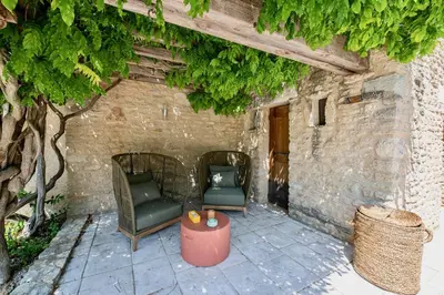 two chairs and a table on a patio at Le Mas Victoria in Gordes