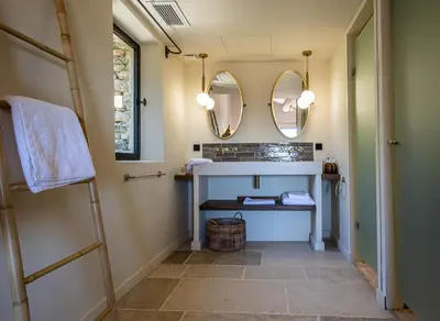 a bathroom with a sink and two mirrors at Le Mas Luca in Gordes
