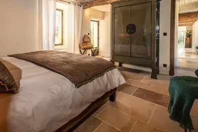 a bedroom with a large bed in a room at Le Mas Luca in Gordes