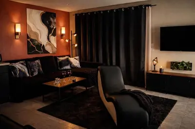 a living room with a couch and a table at Eden House, Cocon sensuel et romantique avec jacuzzi in Carpentras