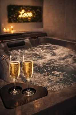 two glasses of champagne in a hot tub at Eden House, Cocon sensuel et romantique avec jacuzzi in Carpentras
