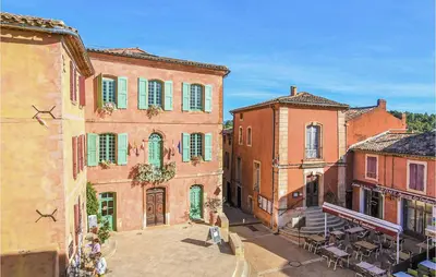 a group of buildings with tables and chairs in a street at Gorgeous Home In Roussillon With Wifi in Roussillon