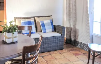 a living room with a table and a chair and a couch at Gorgeous Home In Roussillon With Wifi in Roussillon