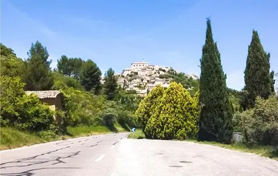 a road with a building on top of a hill at Gorgeous Home In Lioux With Wifi in Lioux
