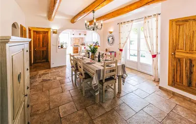 a dining room with a table and a kitchen at Gorgeous Home In Lioux With Wifi in Lioux