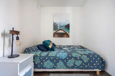 a bedroom with a bed with a blue comforter at Maison de Charme en Provence avec jardin et piscine in Carpentras