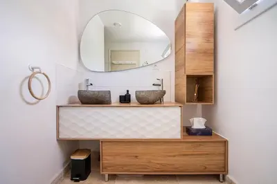 a bathroom with two sinks and a mirror at Maison de Charme en Provence avec jardin et piscine in Carpentras