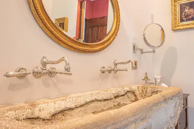 a bathroom with a large sink and a mirror at Prieuré Notre-Dame de Conil - 12e siècle in Rognes