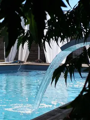 a water fountain in a swimming pool at Cocoon inn&Spa in Saint-Saturnin-les-Avignon