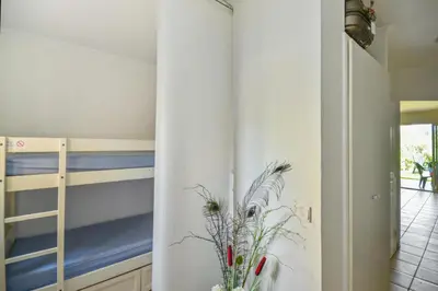 a room with two bunk beds and a plant at Village Pont Royal en Provence - maeva Home - Studio 5 Personnes Selection MAE-4892 in Mallemort