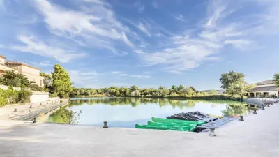 two green boats are docked on a river at Village Pont Royal en Provence - maeva Home - Appartement 2 pièces 6 personnes climatisé - Prestige MAE-4537 in Mallemort