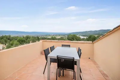 a balcony with a table and chairs on a roof at Village Pont Royal en Provence - maeva Home - Appartement moderne climatisé 4 pièces 8 personnes - Sélection - super Home MAE-8568 in Mallemort