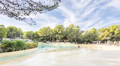a rendering of a beach with people in the water at Village Pont Royal en Provence - maeva Home - Appartement 2 Pièces 6 Personnes - Sélection MAE-9534 in Mallemort