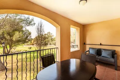 a dining room with a table and a balcony at Résidence Hôtel du Golf de Pont Royal - maeva Home - Appartement climatisé ravissant 2 pièces 4 personnes - Prestige - super Home MAE-3104 in Mallemort