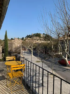 a yellow table and chairs sitting on a balcony at La Terrasse d'Eygalières in Eygalières