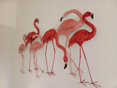 four flamingos standing in a group on a wall at Le Mas Joséphine in Saint-Rémy-de-Provence