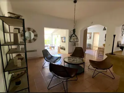 a living room with chairs and a table at Une Oasis au Pays de Cézanne in Aix-en-Provence