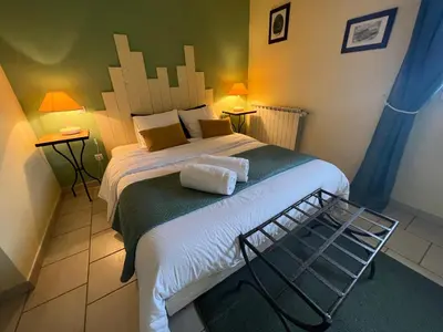 a bedroom with a bed with two towels on it at Mas de l'Estiou in Monteux