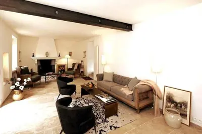 a living room with a couch and chairs and a fireplace at La Borie Oubliée in Gordes