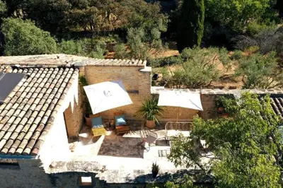an aerial view of a house with umbrellas on the roof at La Borie Oubliée in Gordes