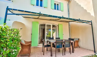a patio with a wooden table and chairs at Les Maisons de Pont Royal en Provence - maeva Home - Maison 3 pièces 6 personnes - Sélection MAE-1676 in Mallemort