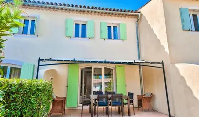 a patio with a table and chairs in front of a building at Les Maisons de Pont Royal en Provence - maeva Home - Maison 3 pièces 6 personnes - Sélection MAE-1676 in Mallemort