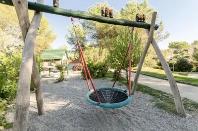a swing yard with two swings and a basket at Les Maisons de Pont Royal en Provence - maeva Home - Maison 3 pièces 6 personnes - Sélection MAE-1676 in Mallemort