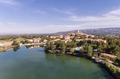 an aerial view of a river with a town at Les Maisons de Pont Royal en Provence - maeva Home - Maison 3 pièces 6 personnes - Sélection MAE-1676 in Mallemort
