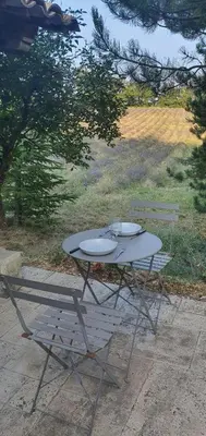 a picnic table and a bench with two plates on it at Aurel inattendu in Aurel