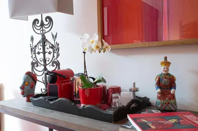 a table with a statue of a woman on a table at Le Clos des Amandiers in Simiane-la-Rotonde
