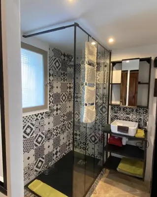 a bathroom with a shower and a sink at Les Remparts de Lauris Coeur Médiéval et Patio in Lauris