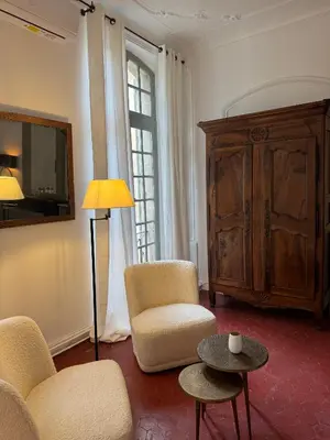 a living room with a couch and chairs and a table at La Chapelle sur la Sorgue in LʼIsle-sur-la-Sorgue