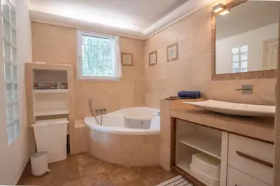 a bathroom with a bath tub and a sink at Maison des lavandes in Saint-Cannat