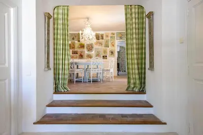 a hallway leading into a dining room with a dining table at Le Clos des Rosiers in Gordes