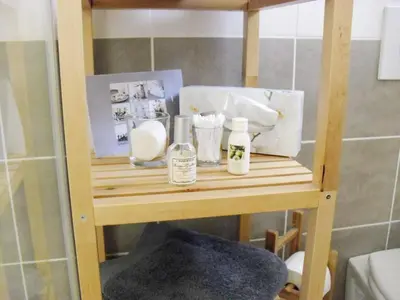 a wooden shelf with items on it in a bathroom at Studio à Deux Pas d'Aix in Aix-en-Provence